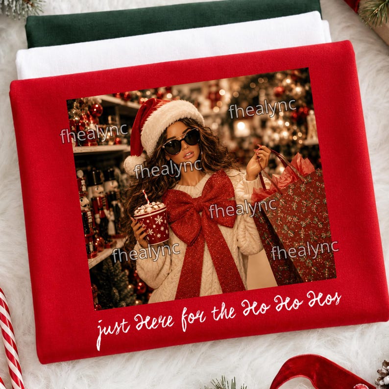 May include: A red sweatshirt featuring a printed graphic of a person wearing a Santa hat, sunglasses, and a cream-colored sweater with a large red bow. The person holds a red mug. The text "just Here for the Ho Ho Hos" is printed in white.
