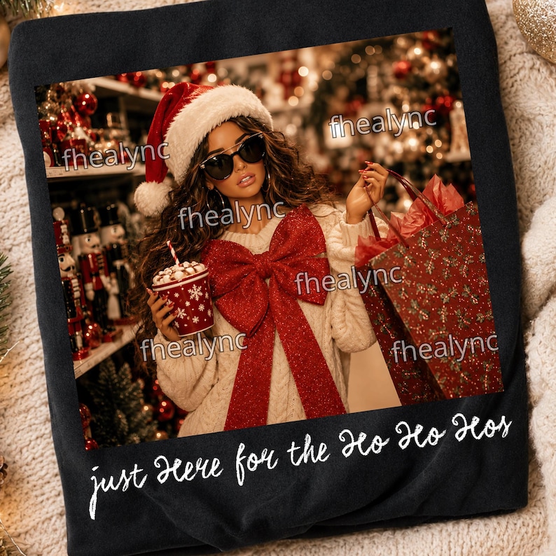 May include: A black t-shirt featuring a graphic of a person wearing a Santa hat, sunglasses, and a cream-colored sweater with a large red bow, holding a red cup and a gift bag. The text "just here for the ho ho hos" is printed in white below.