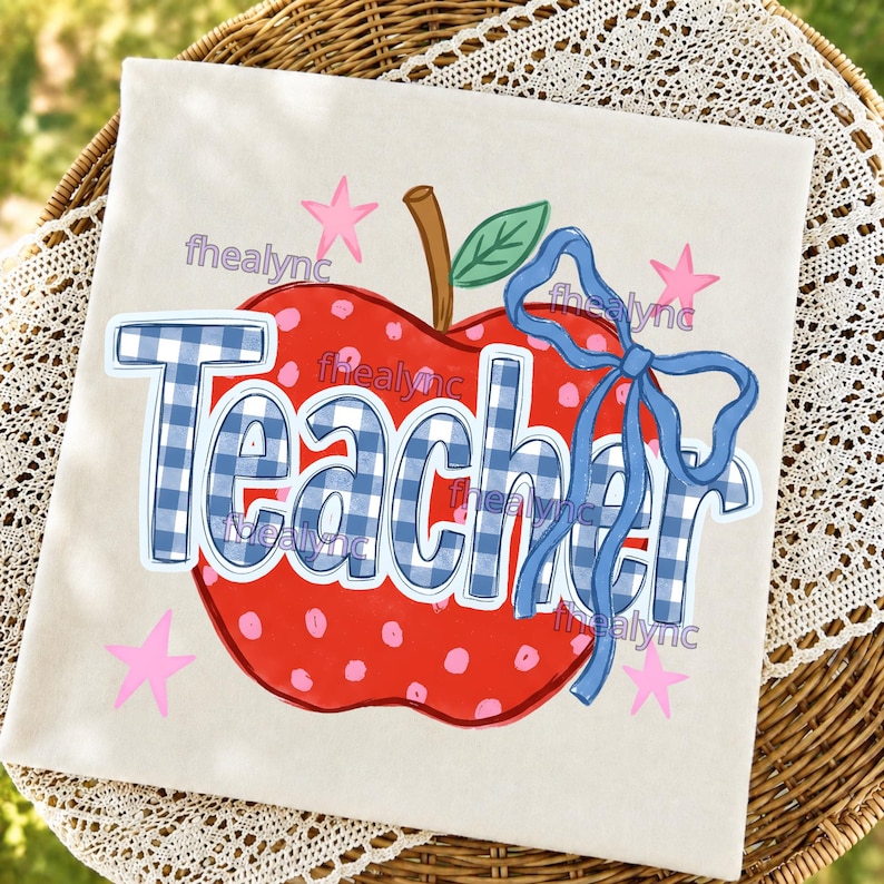 May include: A square off-white fabric item featuring a red apple graphic with pink polka dots, a brown stem, and a green leaf. The word Teacher is printed in a blue and white gingham pattern, accented by a blue ribbon bow and small pink stars.