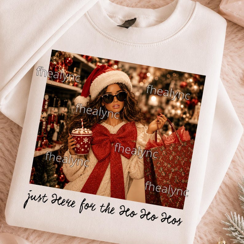 May include: A white crewneck sweatshirt featuring a graphic print of a person wearing a Santa hat and sunglasses, holding a red cup and a red gift bag. The person wears a cream sweater with a large red bow. Text reads: just Here for the Ho Ho Hos.