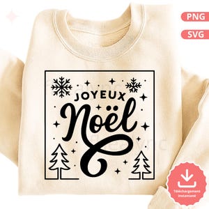 May include: Cream-colored sweatshirt with a black square design that says "JOYEUX Noël" in a script font. The design includes snowflakes, stars, and Christmas trees. The sweatshirt is folded.