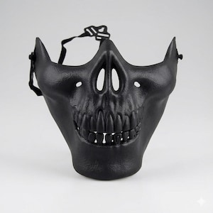 May include: A matte black skull mask with a detailed skeletal design. The mask features eye and nose openings, a full set of teeth, and an adjustable strap. The mask is designed to cover the lower half of the face.