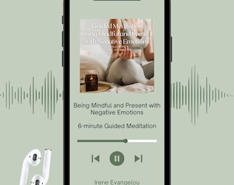 May include: A smartphone displays a guided meditation app with the title "Being Mindful and Present with Negative Emotions." The screen shows a person meditating, a candle, and a play button. White wireless earbuds are in the lower left corner.