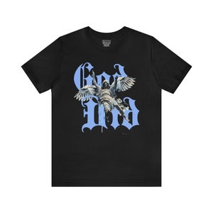 May include: Black t-shirt featuring a blue graphic of an angel with wings and the word "God" in a stylised font.