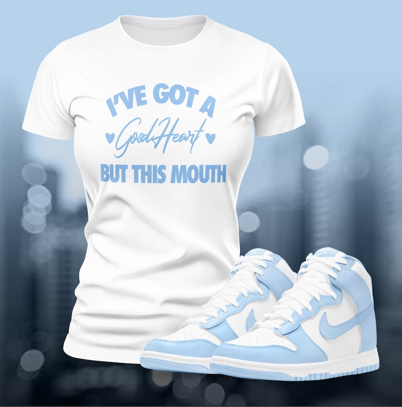 May include: White t-shirt with light blue text that reads "I've got a good heart but this mouth". The text is surrounded by two small hearts. A pair of light blue and white high-top sneakers are below the t-shirt.