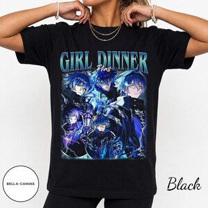 May include: A black short-sleeve t-shirt featuring a graphic print with the text GIRL DINNER and Flins. The design displays multiple anime-style characters with blue hair and glowing yellow eyes, surrounded by blue lightning and dark energy effects.