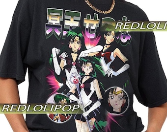 May include: Black t-shirt with a vibrant anime graphic, including multiple characters and Japanese text. The design showcases anime characters with green hair, dressed in black and white attire. The text "REDLOLIPOP" is printed on the shirt.