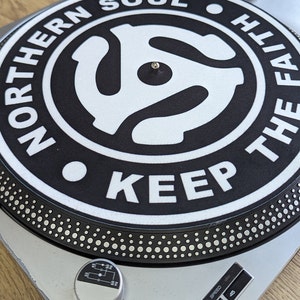 A  top left  shot of the northern soul keep the faith Adapter slip mat 12" on a deck from modmat