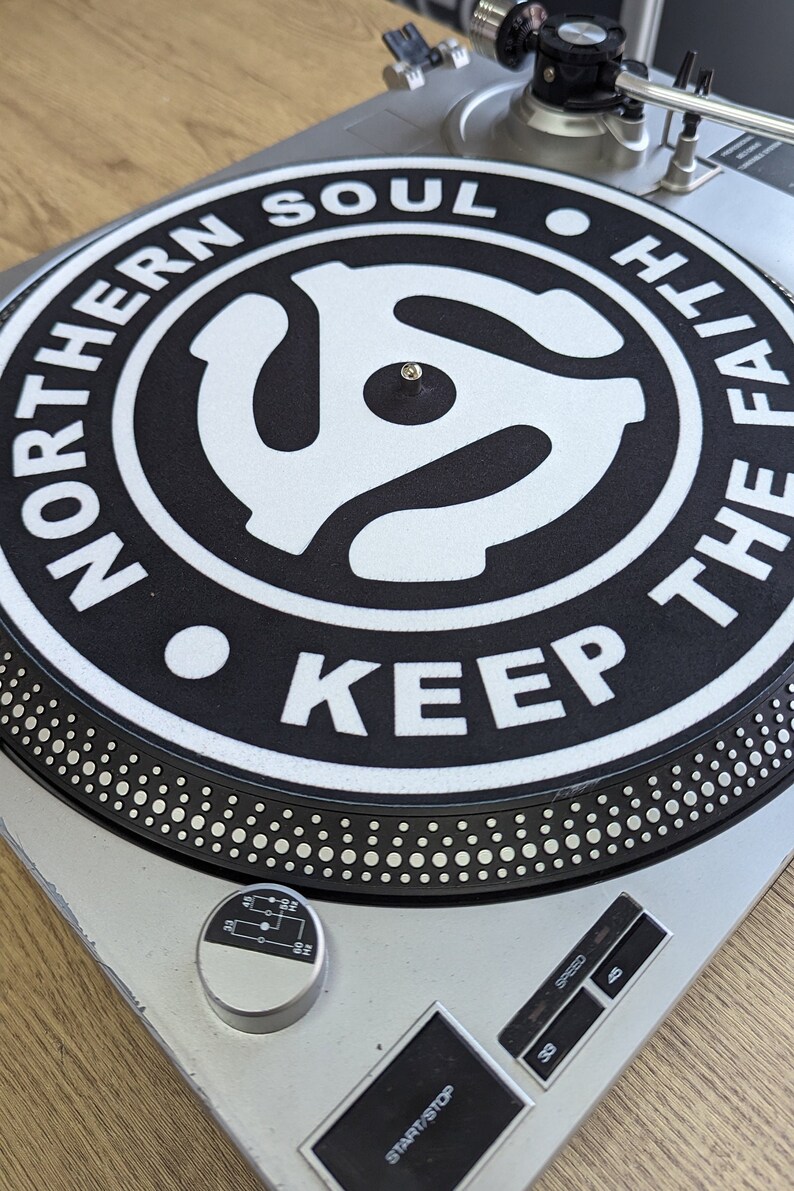 A  top left  shot of the northern soul keep the faith Adapter slip mat 12" on a deck from modmat