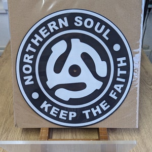 A  top down shot of the northern soul keep the faith Adapter slip mat in its recycled packaging