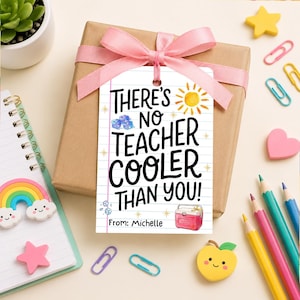May include: A gift box wrapped in brown paper and tied with a pink ribbon. A tag with the text "THERE'S NO TEACHER COOLER THAN YOU!" hangs from the ribbon. The tag includes a sun, ice cubes, and a cooler illustration.