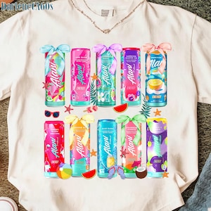 May include: A white t-shirt featuring a colorful arrangement of Alani Nu energy drink cans. Each can is decorated with tropical themes, bows, and various flavors. The shirt also includes sunglasses, starfish, and watermelon slices.