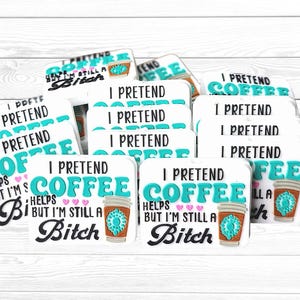 May include: A white ceramic mug with a black handle and the text "But First, Coffee" in a black, bold font. The mug is sitting on a wooden surface. The mug is approximately 4 inches tall.