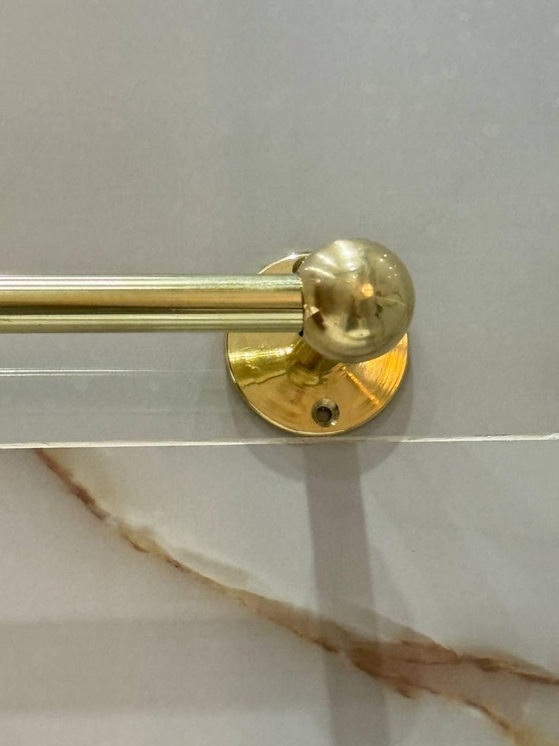 Side profile of the wall-mounted towel bar showing sturdy end post and set screw. Slim, space-saving design coordinates with brass faucets, shower sets, and towel rings; patina-ready finish.