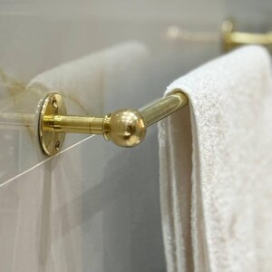 Installation flat-lay: towel bar brackets, screws, anchors, and hex key. Easy DIY install on drywall or tile; standard American hardware. No clear coat—true unlacquered brass that ages beautifully.