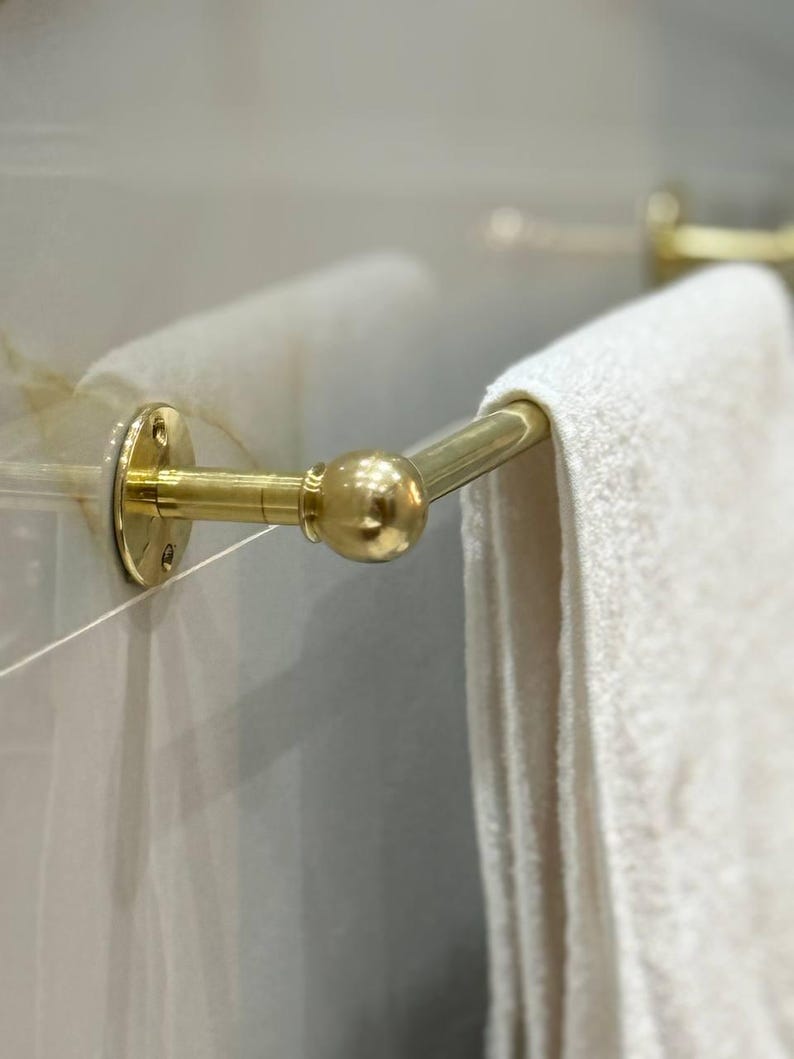 Installation flat-lay: towel bar brackets, screws, anchors, and hex key. Easy DIY install on drywall or tile; standard American hardware. No clear coat—true unlacquered brass that ages beautifully.