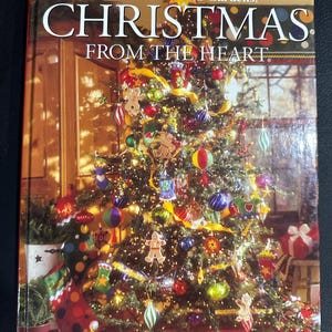 May include: A book titled "Better Homes and Gardens Christmas From The Heart" with a colorful Christmas tree on the cover.