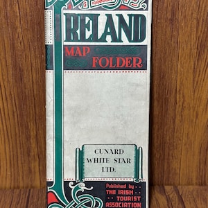 May include: Vintage Ireland map folder with green, red, and white accents. The cover features the word "IRELAND" in large green letters, with "MAP FOLDER" below. The Cunard White Star Ltd. logo is also visible.