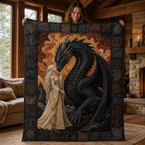 May include: A rectangular quilt featuring a large, dark, scaled dragon facing a person with long blonde hair in a flowing gold gown. The central scene is surrounded by a dark, patterned border with intricate, repeating geometric and knotwork designs.