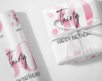 May include: White gift wrap with a pink watercolor design of the number 30 and the text "Thirty". The text "Happy Birthday Louise" is also printed on the wrap.