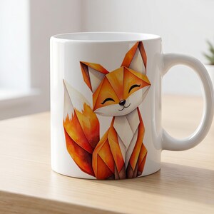 Könnte beinhalten: Ein weißer Keramikbecher mit einer bunten Grafik eines Fuchses, der aus geometrischen, origamiartigen Formen besteht. Der Fuchs ist in Orange-, Gelb- und Weißtönen gehalten und hat eine kleine schwarze Nase sowie geschlossene Augen.