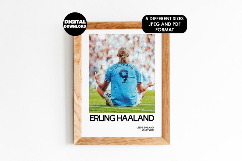May include: A digital print of a soccer player sitting in a meditative pose on a green field. The player is wearing a light blue jersey with the number 9 on the back. The text "ERLING HAALAND" is printed below the image. The text "LEEDS, ENGLAND 21 JULY 2000" is printed below the text "ERLING HAALAND".