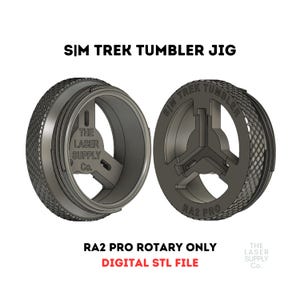 May include: A 3D printed jig for a rotary tumbler, designed for use with the RA2 Pro rotary tumbler. The jig is black and has the text "SIM TREK TUMBLER" and "RA2 PRO" printed on it. The jig is designed to be used with a rotary tumbler to help polish and clean metal parts.