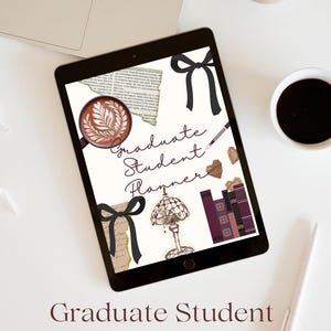 May include: A digital tablet displaying a "Graduate Student Planner" design with decorative elements like bows, hearts, and books. A laptop, coffee cup, and pen are also visible.