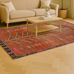 Pode incluir: Uma sala de estar com um tapete retangular vibrante em vermelho-alaranjado. O tapete tem um design detalhado com detalhes em azul, verde e rosa. A sala inclui um sofá bege, uma mesa de centro de madeira e uma obra de arte abstrata emoldurada. O tapete mede cerca de 200 cm x 300 cm.