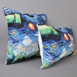 May include: Two decorative throw pillows with a blue, green, and white starry night print. The pillows feature a ghost and a red and orange fish.