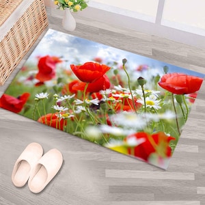 May include: A red poppy flower field rug with white daisies. The rug has a light blue sky background with white clouds.