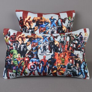 May include: Two decorative throw pillows with a colorful print of various superheroes. The pillows are made of a soft, textured fabric.
