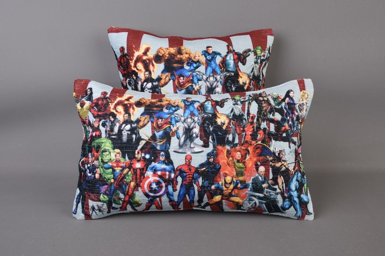 May include: Two decorative throw pillows with a colorful print of various superheroes. The pillows are made of a soft, textured fabric.