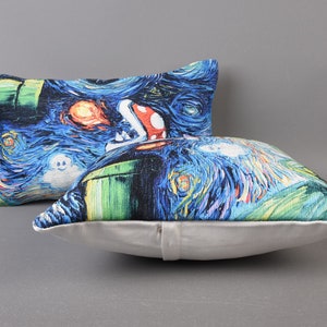 May include: Two decorative throw pillows with a blue, green, and white print of a video game character in a starry night scene.