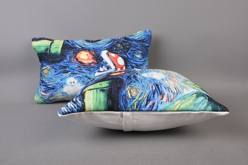 May include: Two decorative throw pillows with a blue, green, and white print of a video game character in a starry night scene.