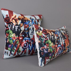 May include: Two decorative throw pillows with a colorful print of various superheroes. The pillows are made of a soft, comfortable fabric and feature a zipper closure.