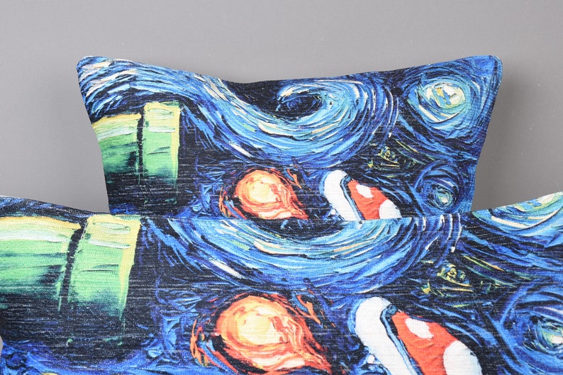 May include: Two blue and black throw pillows with a swirling, abstract pattern reminiscent of a famous painting. The pattern includes green, orange, and red accents.