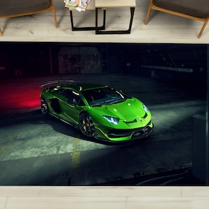 May include: A bright green Lamborghini Aventador SVJ Roadster parked in a dark garage with red lighting. The car has a black front splitter and a black rear diffuser.