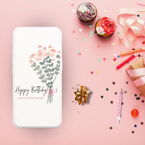 May include: A pink background with a white smartphone displaying a birthday card with a bouquet of pink and green flowers and the text "Happy Birthday I wish you all the very best". The background also includes a pink and white birthday candle, a gold bow, a pink balloon, cupcakes with pink and white frosting, and pink and silver confetti.