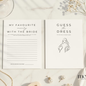 May include: Two white cards with black text for a bridal shower. One card reads "MY FAVOURITE memory WITH THE BRIDE" and the other reads "GUESS the DRESS" with a line drawing of a woman. Gold necklace and earrings are also in the image.