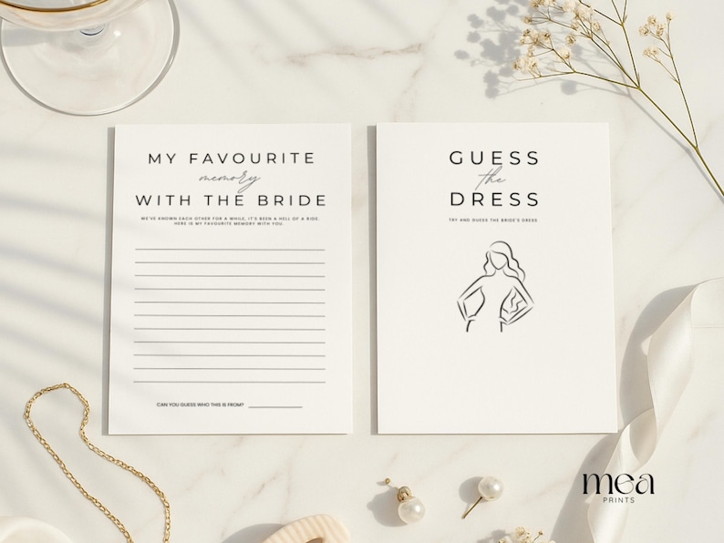 May include: Two white cards with black text for a bridal shower. One card reads "MY FAVOURITE memory WITH THE BRIDE" and the other reads "GUESS the DRESS" with a line drawing of a woman. Gold necklace and earrings are also in the image.