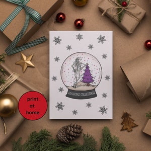 May include: A white greeting card with a snow globe design featuring skeletons and a purple Christmas tree. The text "SEASONS CREEPINGS" is below the globe. The card is surrounded by wrapped gifts, ornaments, and holiday decor.