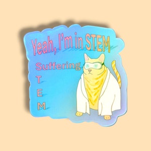 May include: A blue and pink sticker featuring a cartoon cat wearing goggles and a lab coat. The text on the sticker reads "Yeah, I'm in STEM Suffering T E M".