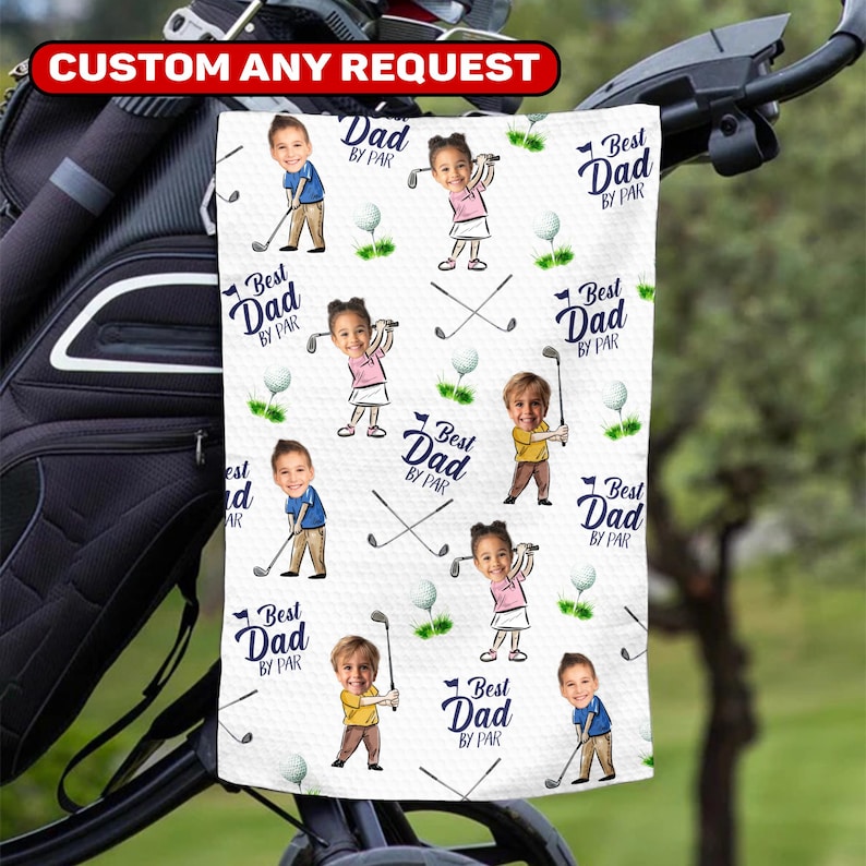 May include: White golf towel with a repeating pattern of cartoon children playing golf, golf balls, and crossed golf clubs. The text "Best Dad by Par" is also featured. The top of the towel has the text "CUSTOM ANY REQUEST".