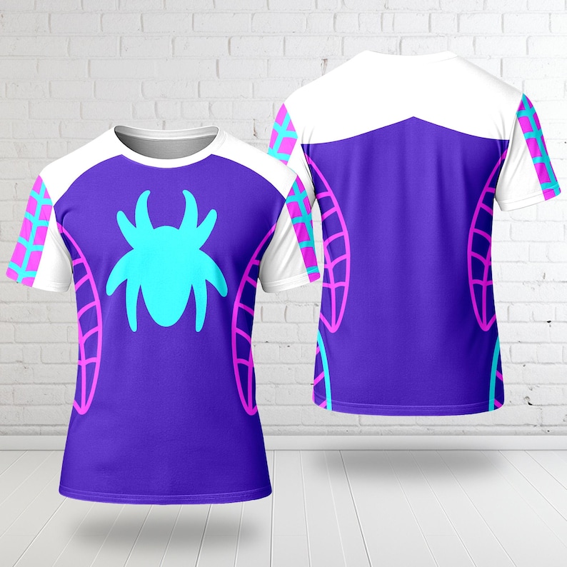 May include: A purple t-shirt featuring a large teal spider design on the front. The shirt has white sleeves with pink and teal accents. The back of the shirt is also visible, showing a similar design.