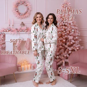 May include: White pajama set with a festive print of nutcrackers, Christmas trees, and rocking horses. The pajamas have a button-down top and matching pants. The text "PAJAMAS SET", "SOFT & BREATHABLE", and "S-5XL" are visible in the image.
