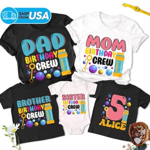 May include: Set of five black t-shirts with colourful bubble-themed birthday crew designs. The shirts feature the text "Dad Birthday Crew", "Mom Birthday Crew", "Brother Birthday Crew", "Sister Birthday Crew", and "Alice 5 Birthday Crew".