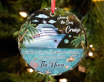 May include: A clear, round Christmas ornament with a cruise ship design. The ornament features the text "Icon of the Seas Cruise" and "The Nova". Additional text includes locations and the date November 02, 2024. A red ribbon is attached for hanging.