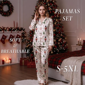 May include: Cream-colored pajama set with a festive print of nutcrackers, rocking horses, and Christmas trees. The long-sleeved top and pants are adorned with the words "SOFT & BREATHABLE" and "PAJAMAS SET". Available in sizes S-5XL.