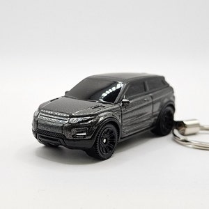 May include: A black Range Rover Evoque keychain with a silver key ring. The car is a detailed miniature replica with a black paint finish.